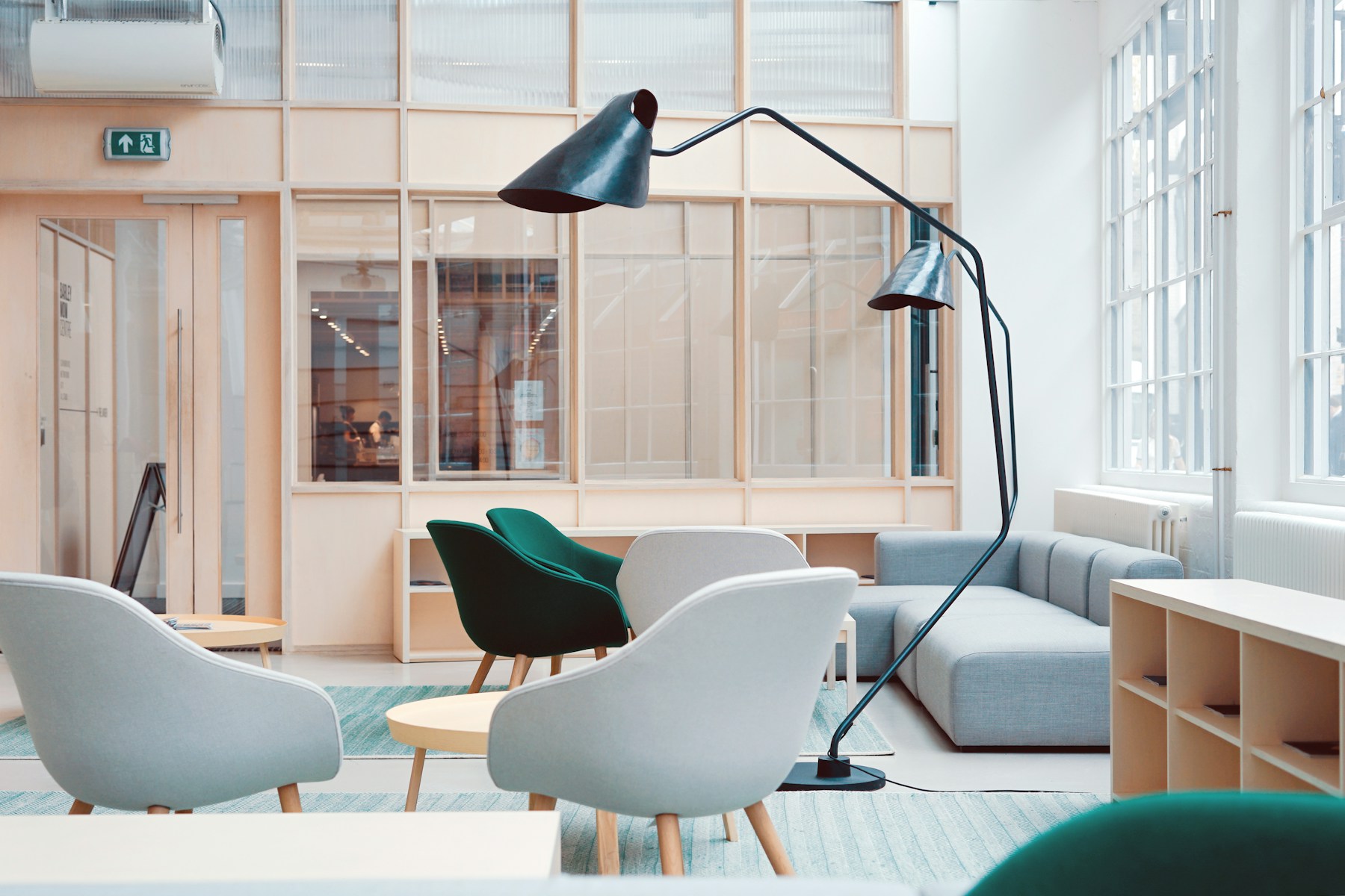 Bright collaborative workspace with meeting tables and lounge seating